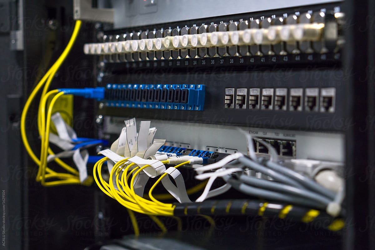 Close up of communications switches with yellow fiber cables