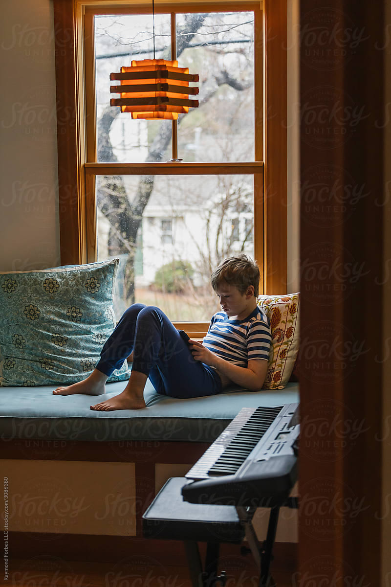Boy at Home playing on Tablet Computer