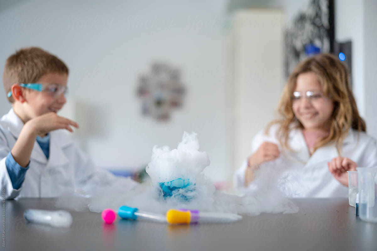 Cheerful kids laughing at chemical reaction