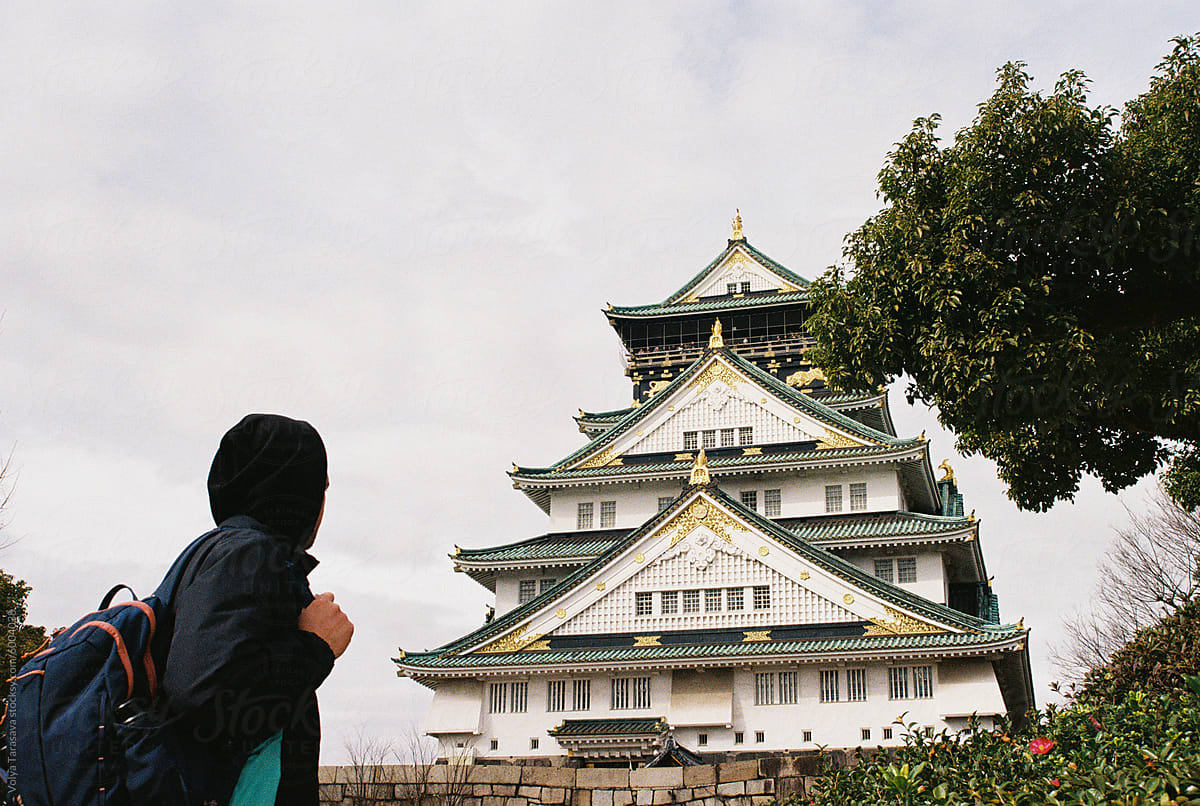 Anonymous man looking at Osaka castle