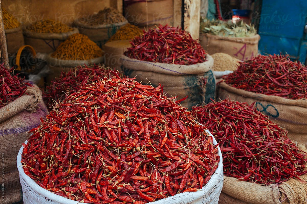 Heaps of red pepper and other spices for sale in a bazaar.
