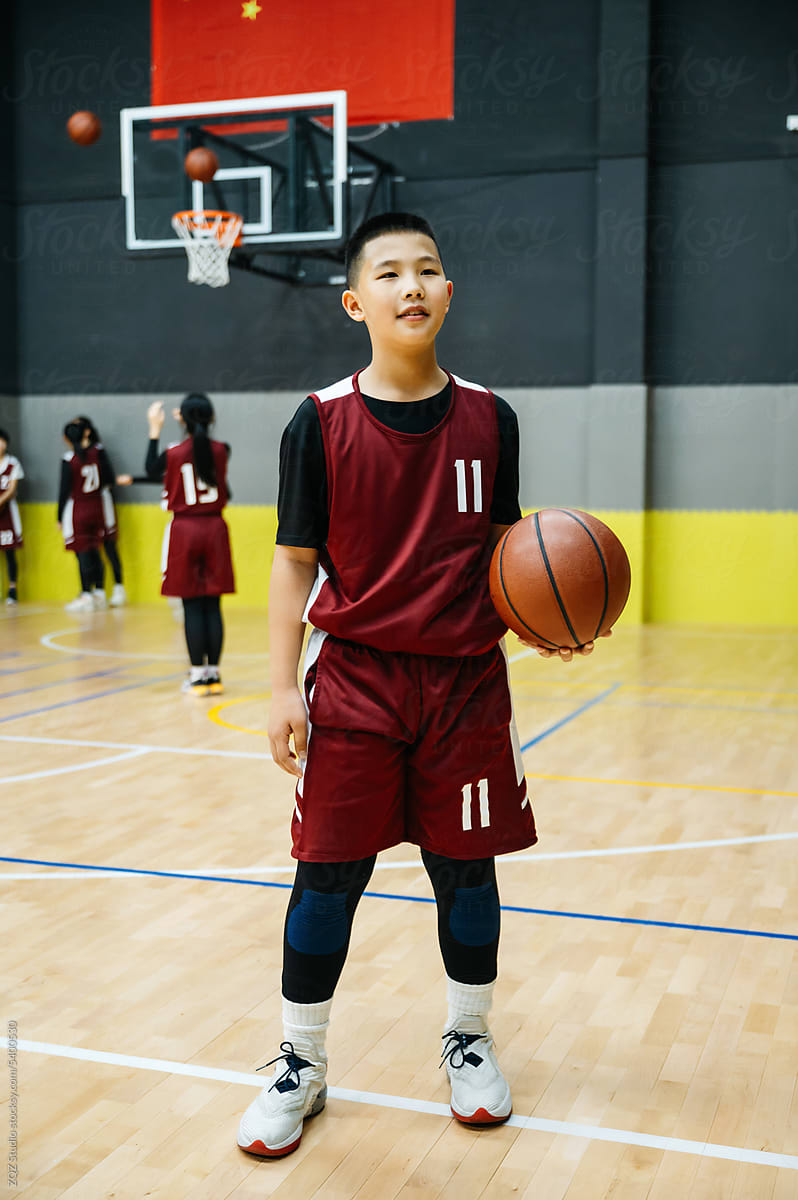 Portrait of basketball boy standing in a gym