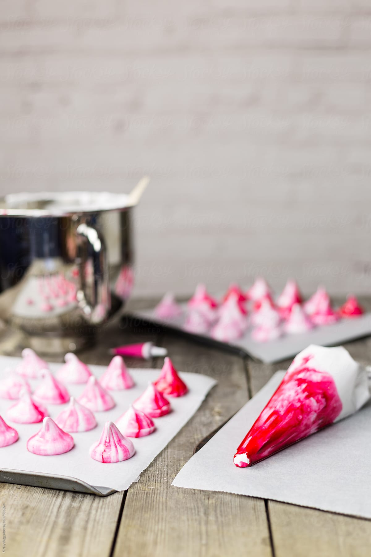 Piping bag filled with meringue and pink food colouring