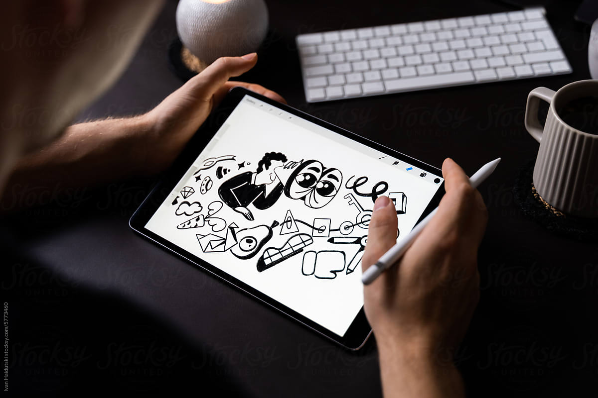 Artist drawing illustration on digital tablet in cozy home workplace