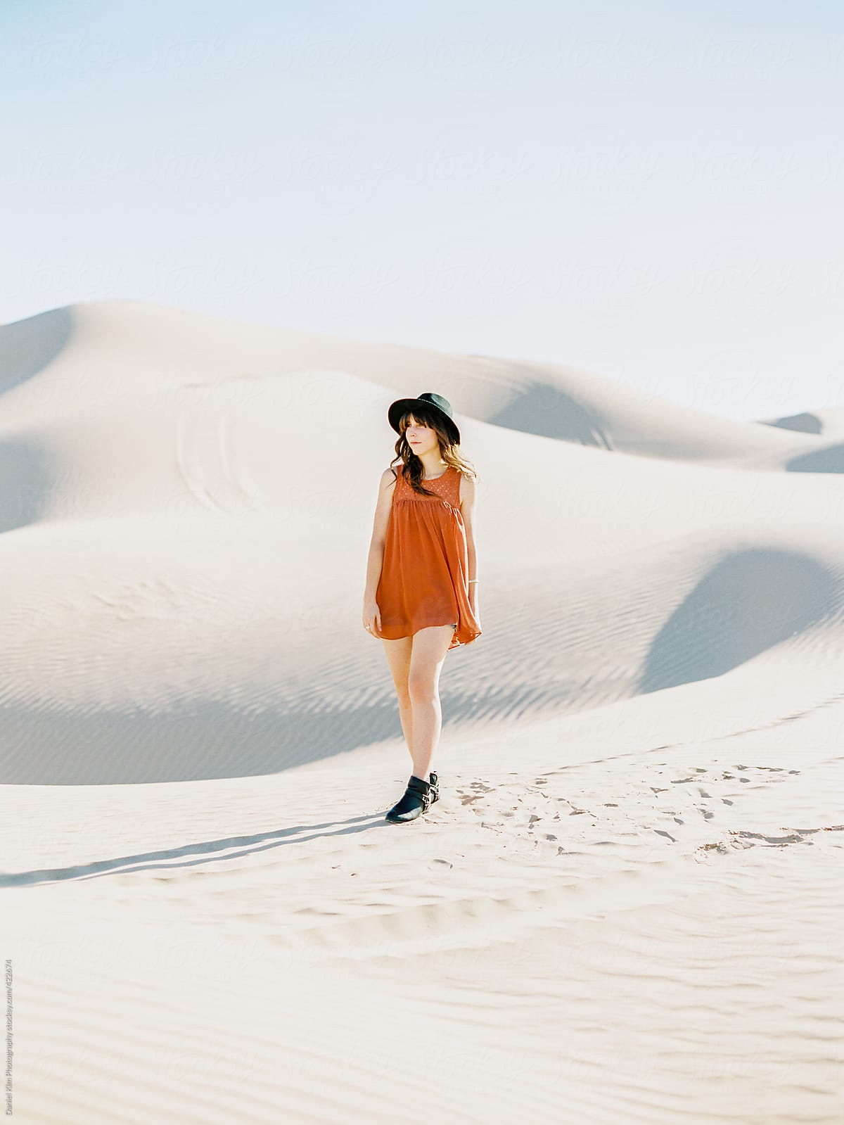 Young woman walking on sand dunes