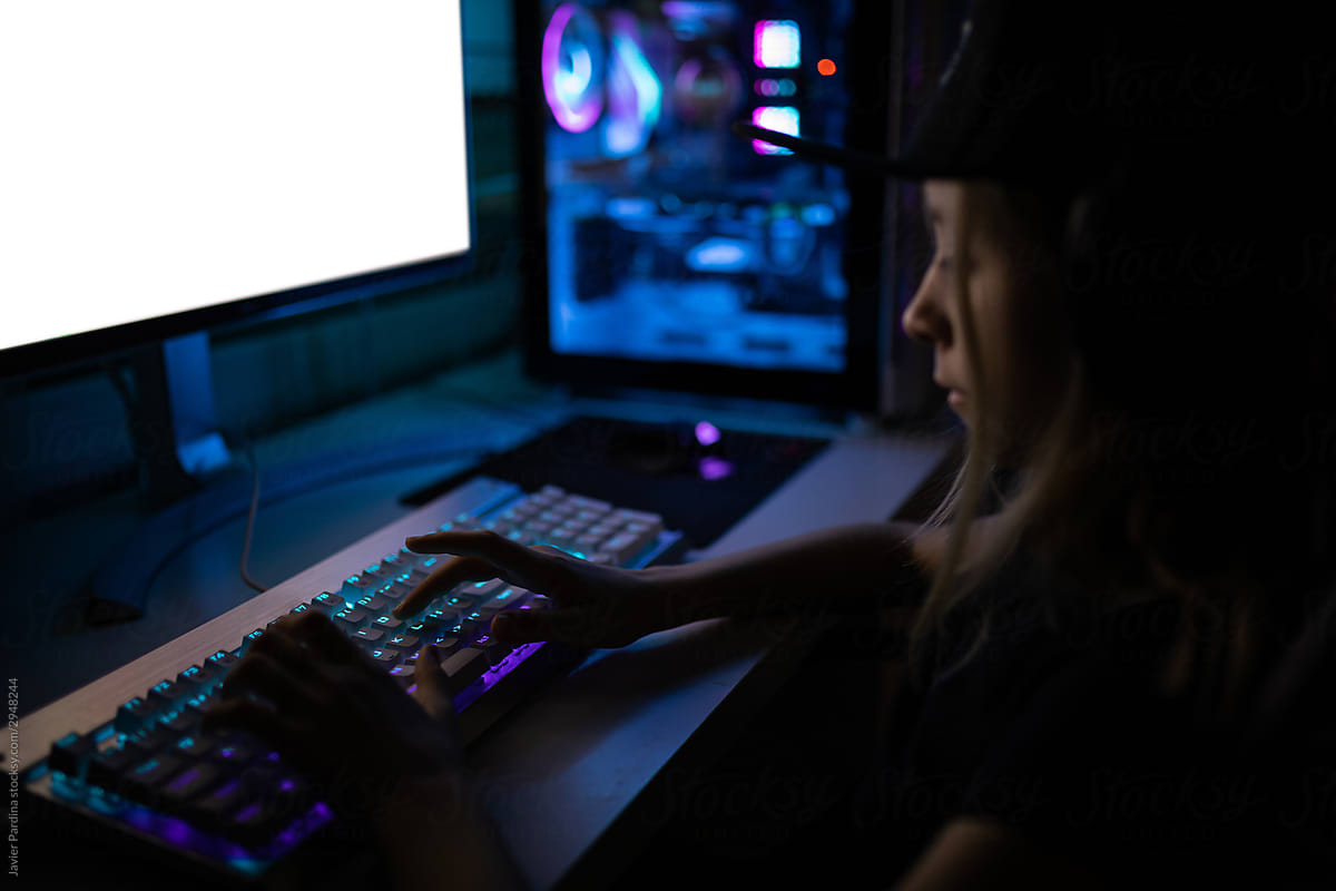 Gamer girl playing on the computer, at home.