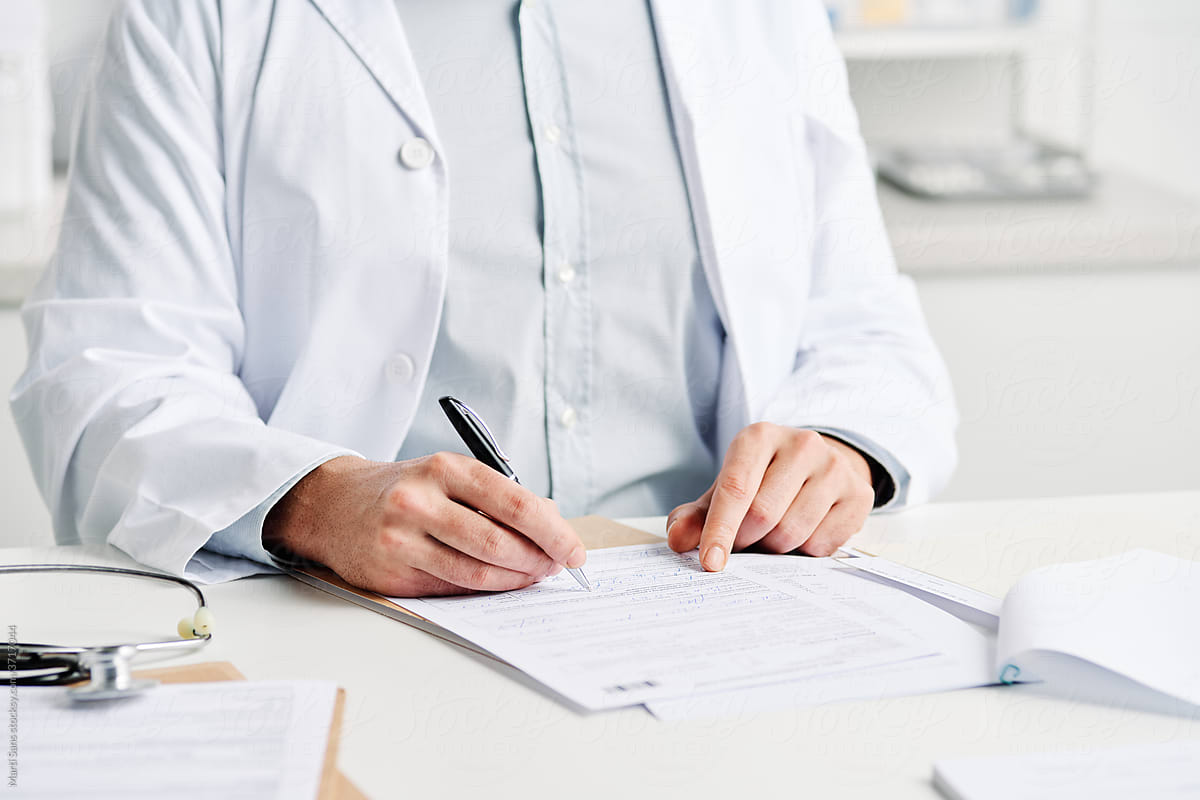 Crop doctor writing medical report in clinic