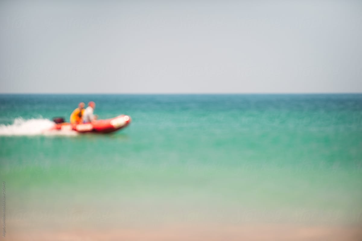Blurred image of surf lifesavers in a rescue boat