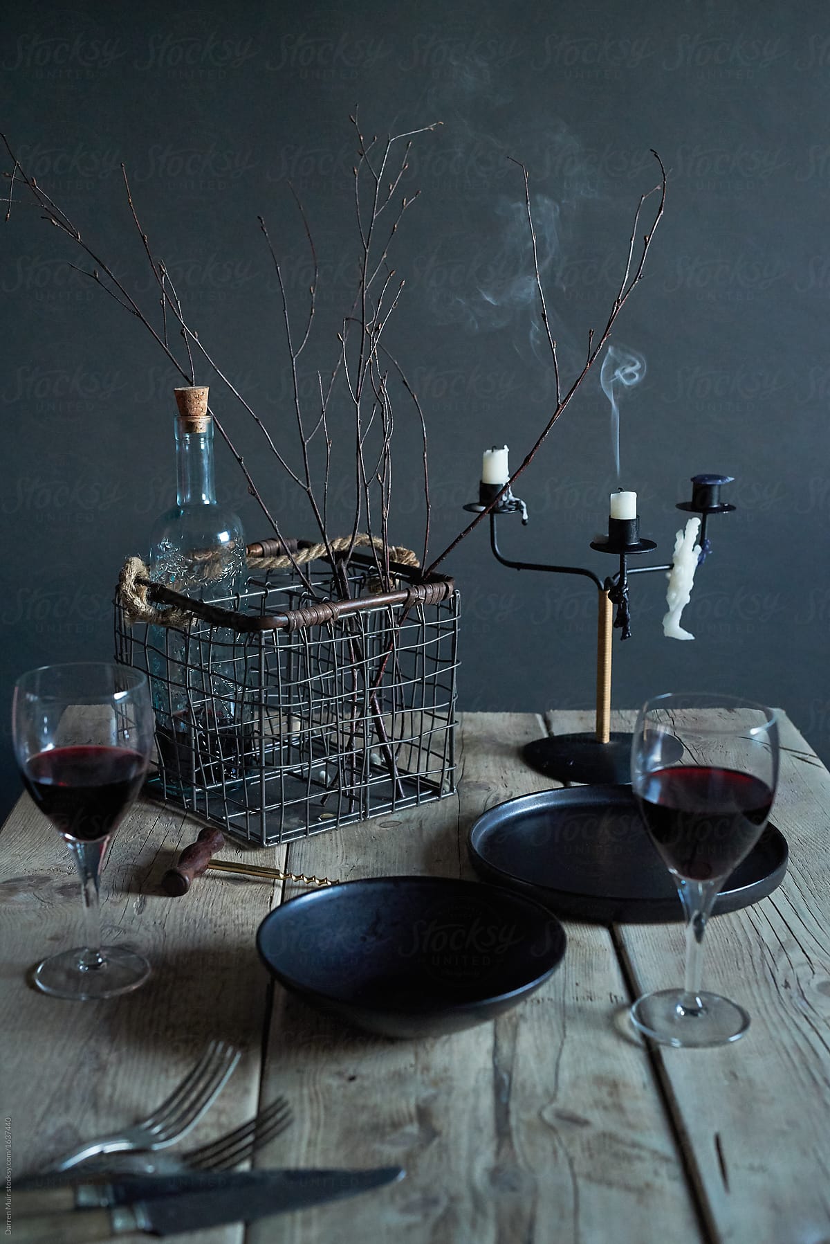 Couple of glasses of wine on a rustic wooden table scape.