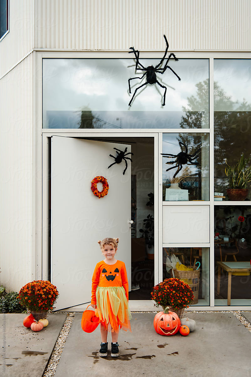 Girl in pumpkin dress, ready for trick or treating on Halloween