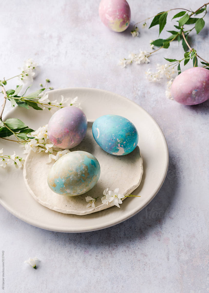 Colorful dyed eggs on plates