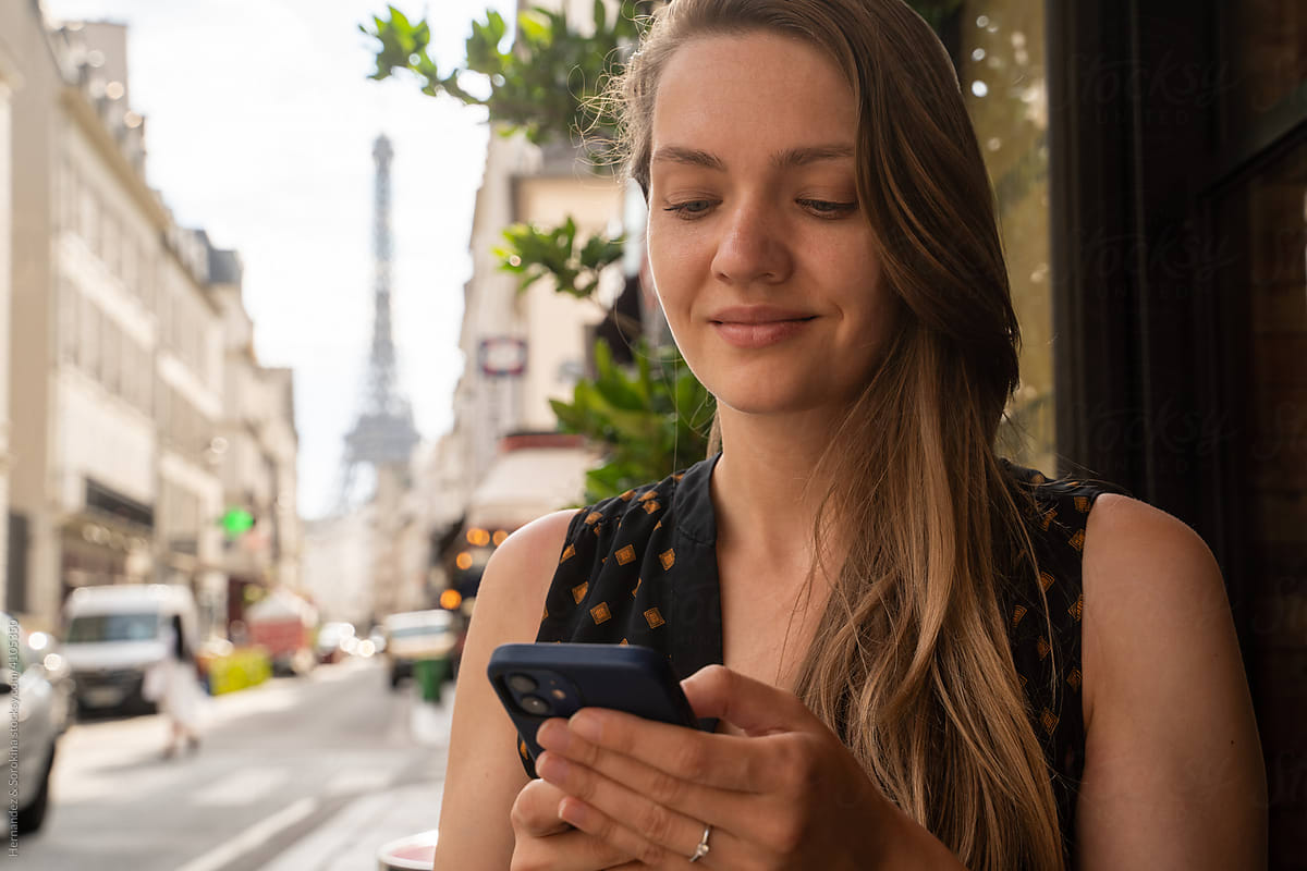 Woman Using Phone In Paris
