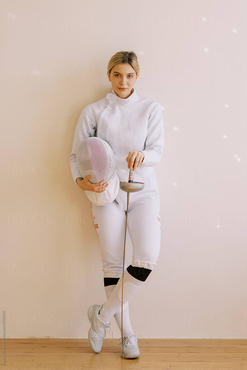 portrait of young woman with fencing uniform .