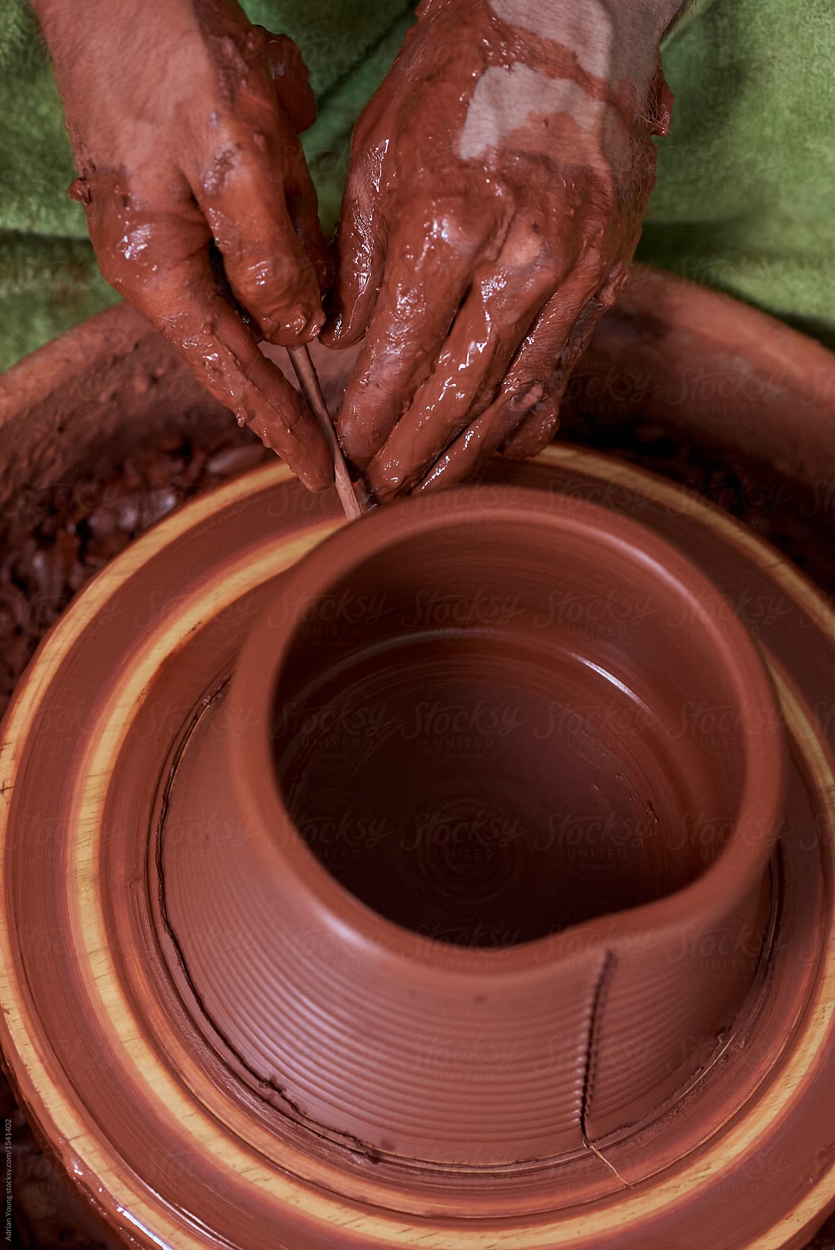 Potter Cutting Grooves On Terra Cotta Pot