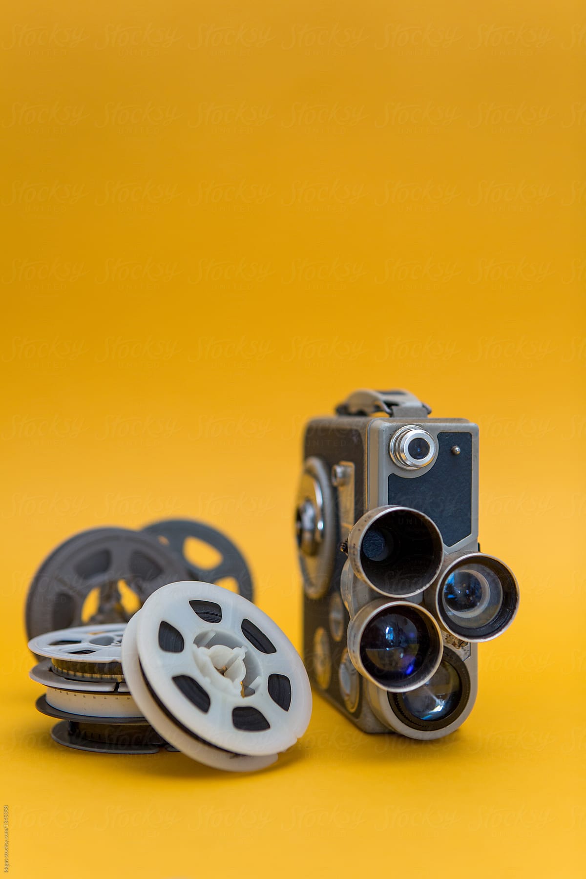 Vintage Cinema Camera And Reels Over Yellow Background by Stocksy  Contributor Kkgas - Stocksy