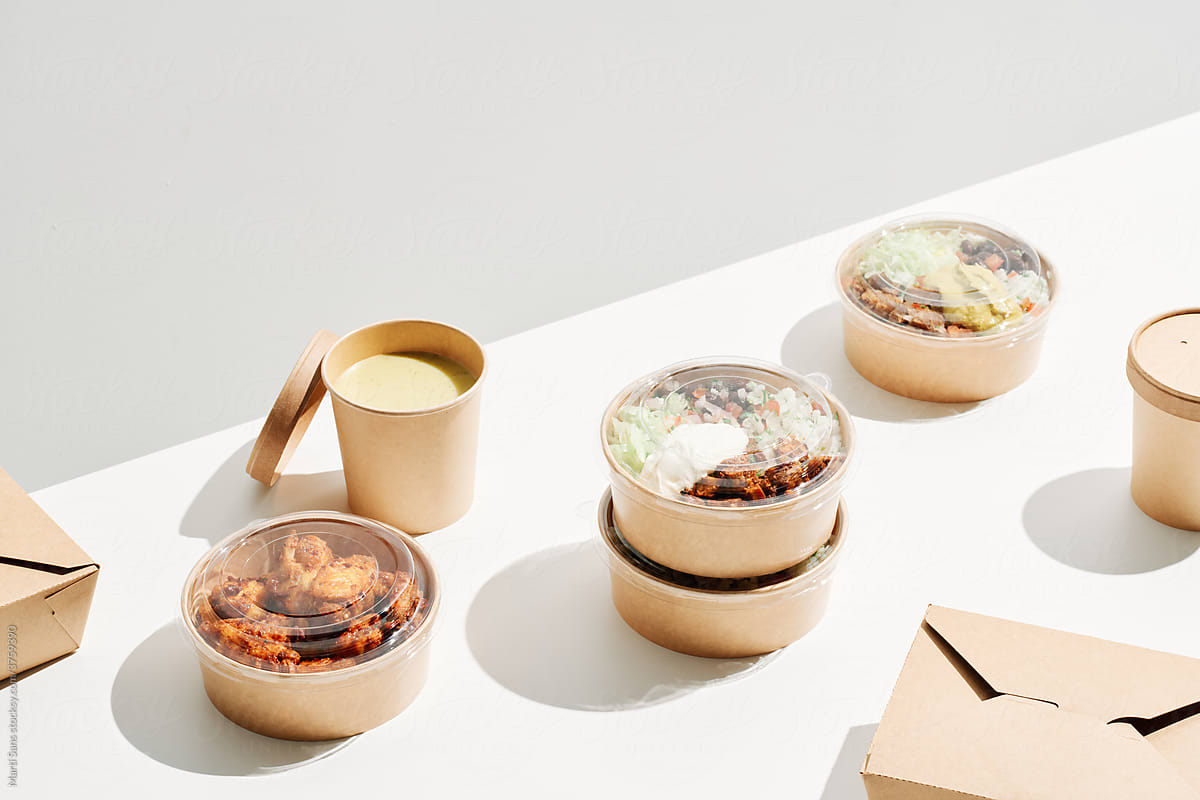 Takeaway food in disposable containers on table