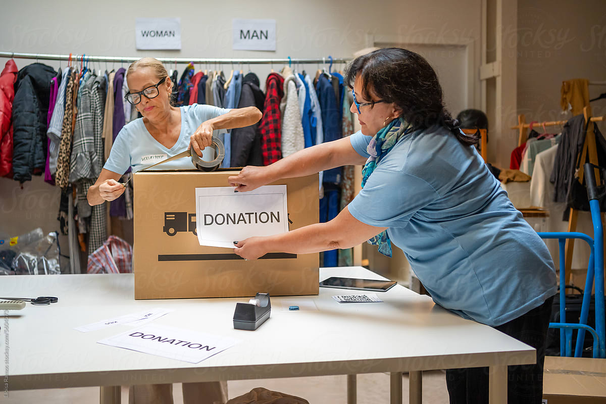 two matures women volunteering in a donation center