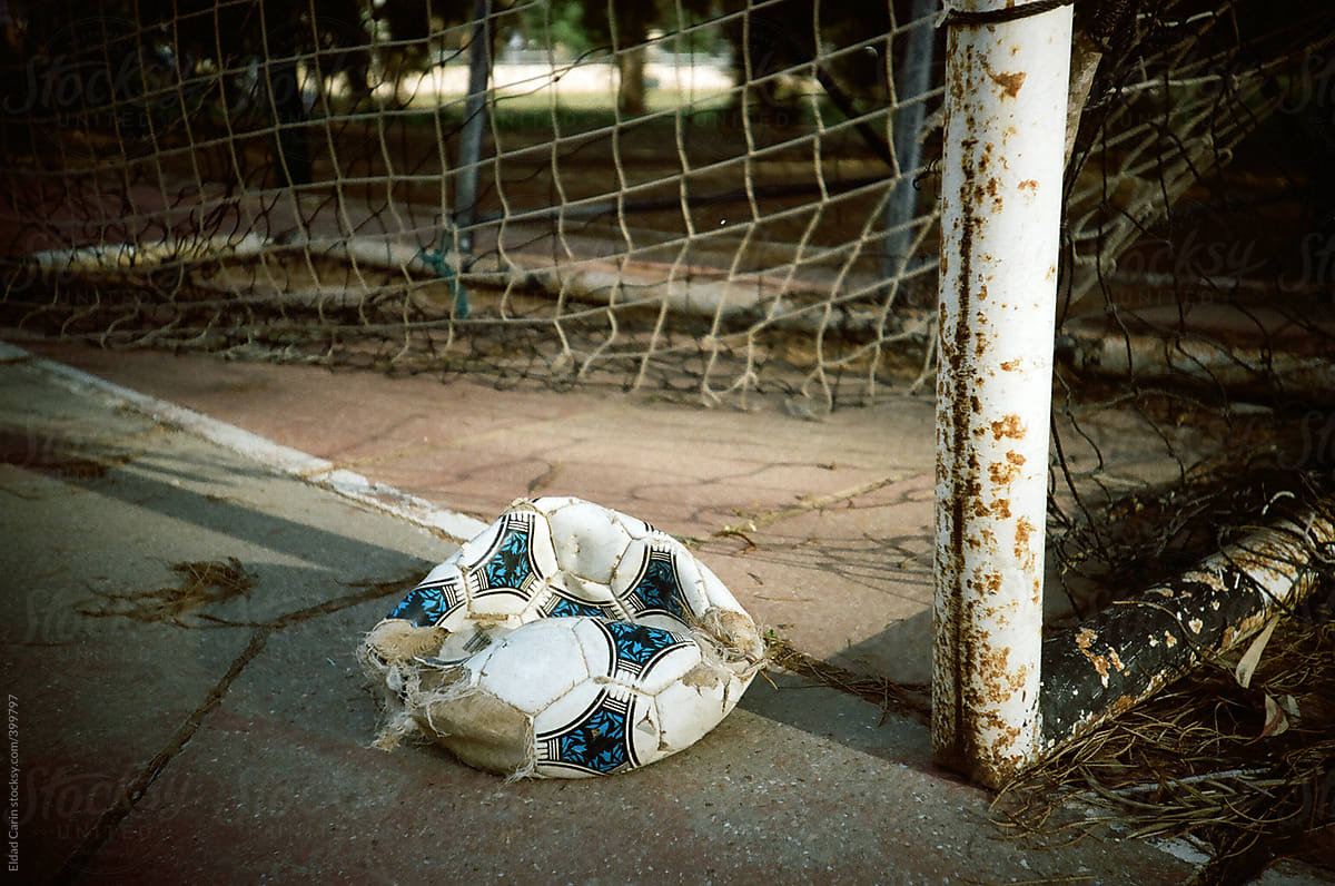 Deflated Soccer Ball in Court by Goal