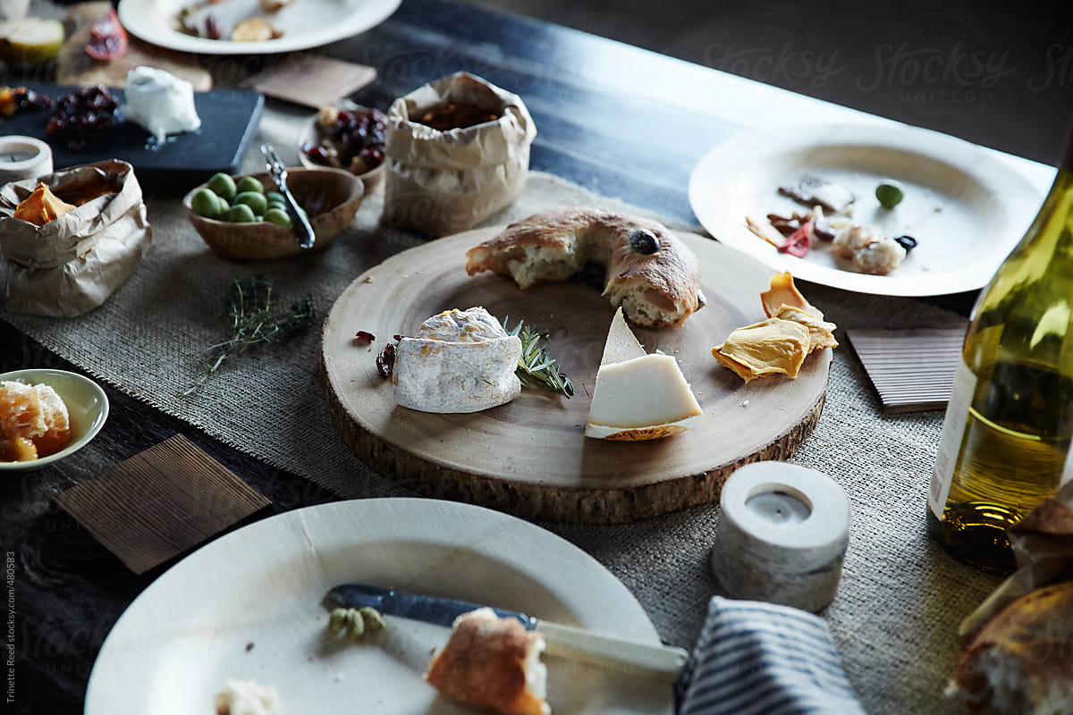 Half eaten picnic food on wood table after dinner party