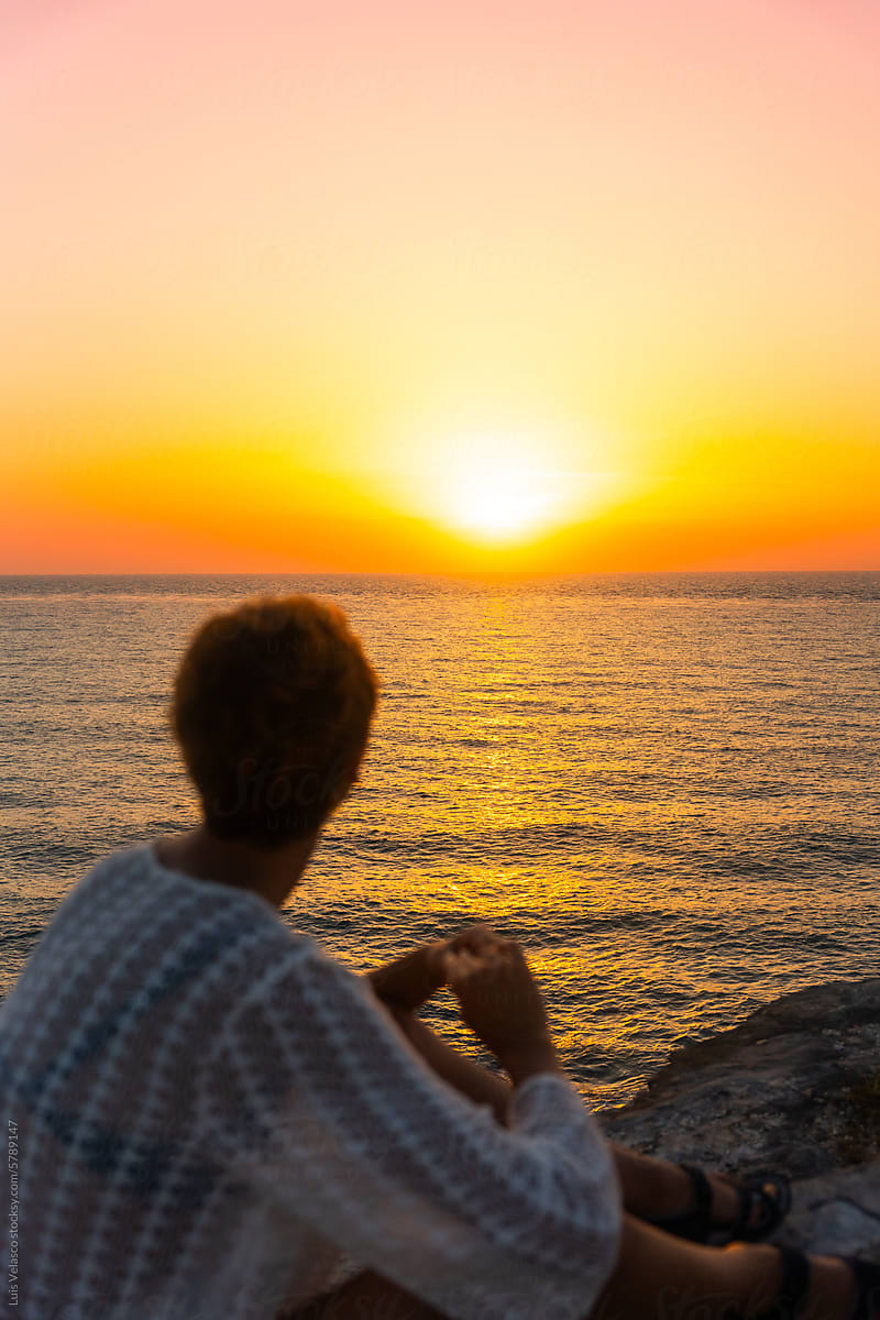 Woman Contemplating The Sunrise Near The Sea In Isla Mujeres Mexico.