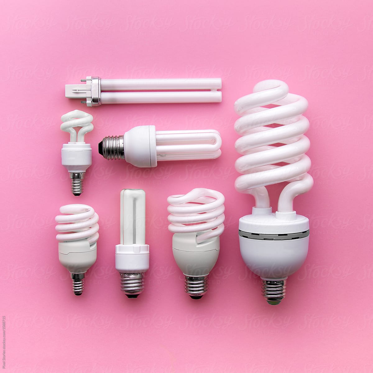 Energy-saving light bulbs on pink background