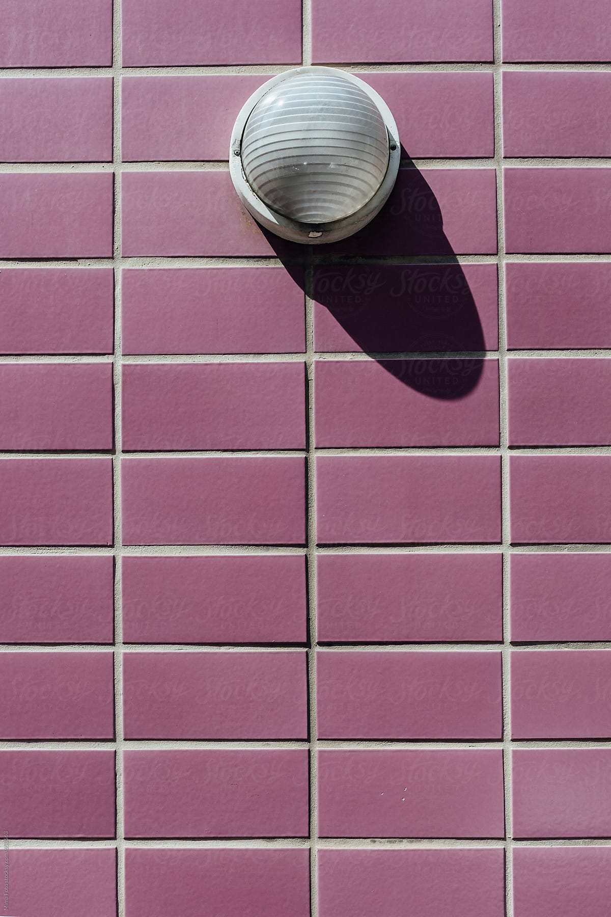 Lamp on purple tile wall