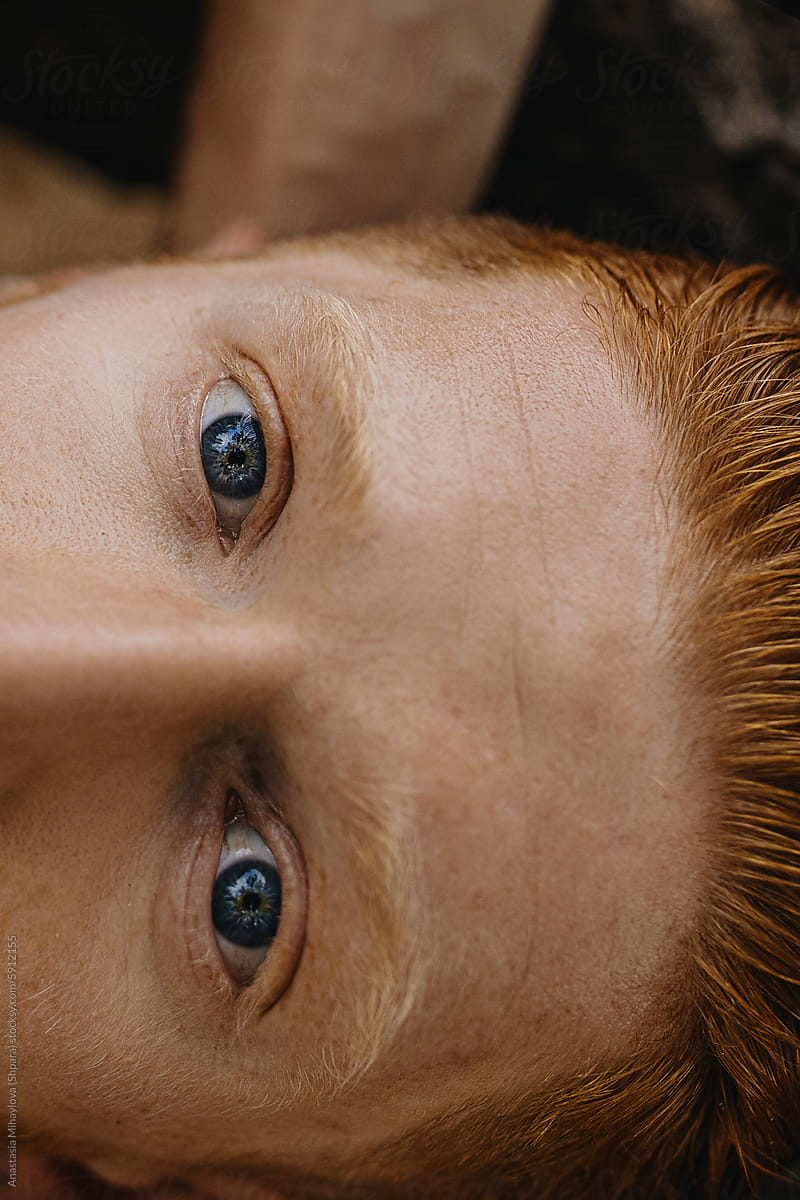 Close up  portrait of Redhead man with freckles and blue eyes