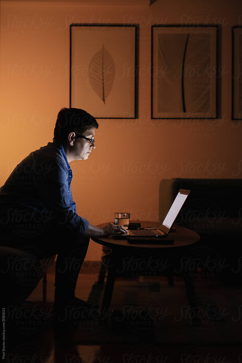 Woman working from home during the night