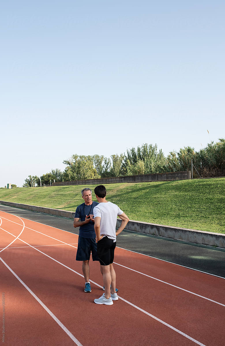 Trainer discussing strategy with male athlete