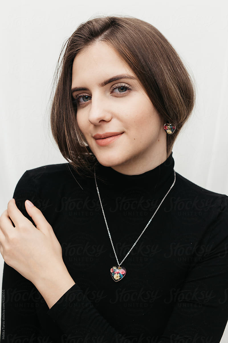 woman wearing floral epoxy necklace and earrings