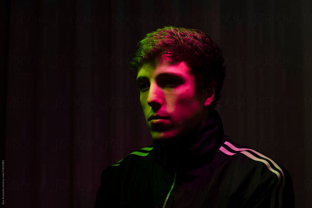 Neon light dark portrait of urban young man