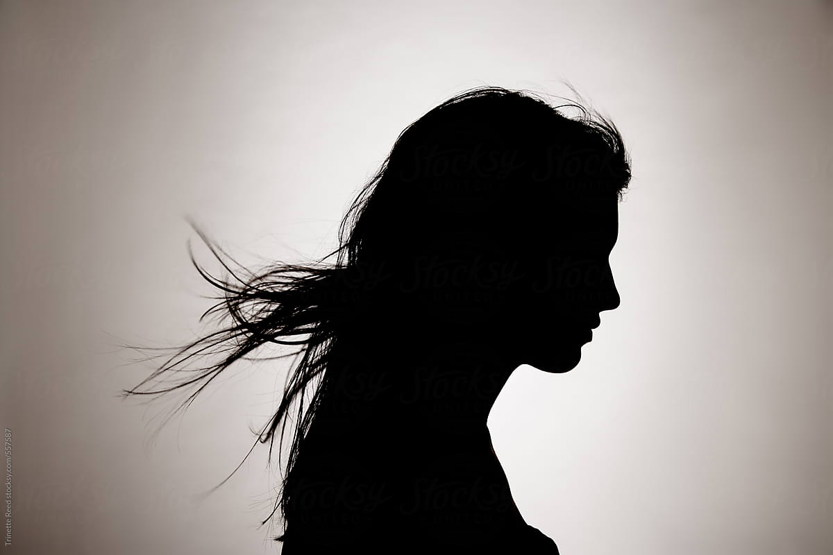 Silhouette portrait of woman with hair blowing