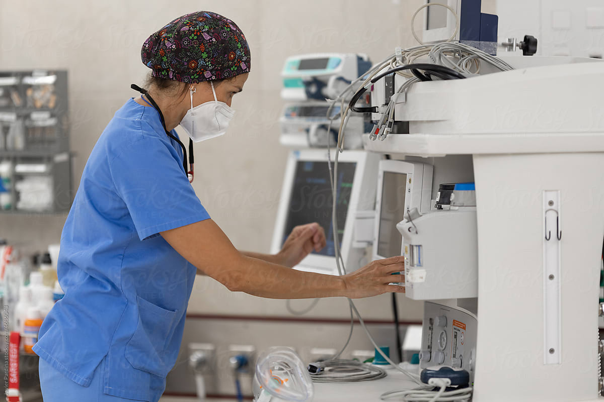 Nurse preparing settings of a mechanical ventilation machine