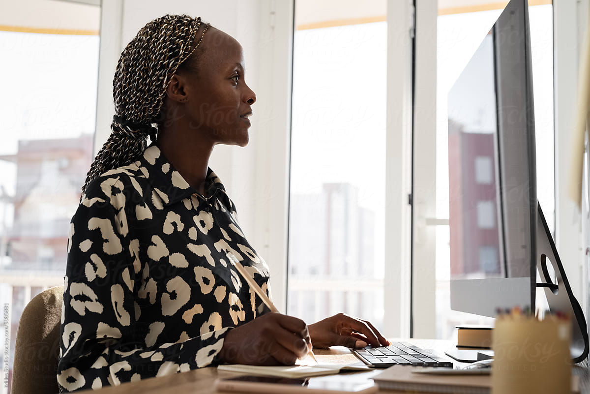 Black female freelancer working on desktop