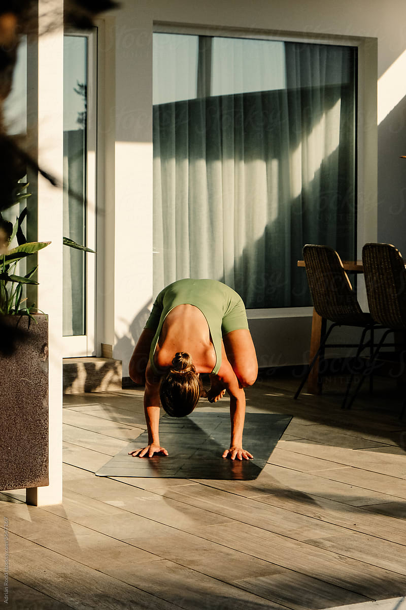 25-35-YearOld Woman Practicing Yoga in a Hotel Suite Amidst Lush Green