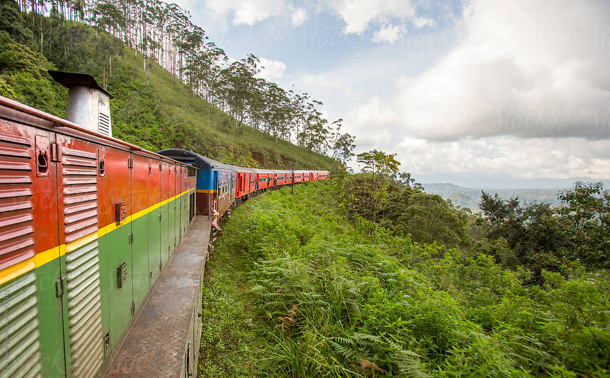 Long passenger train on hillside