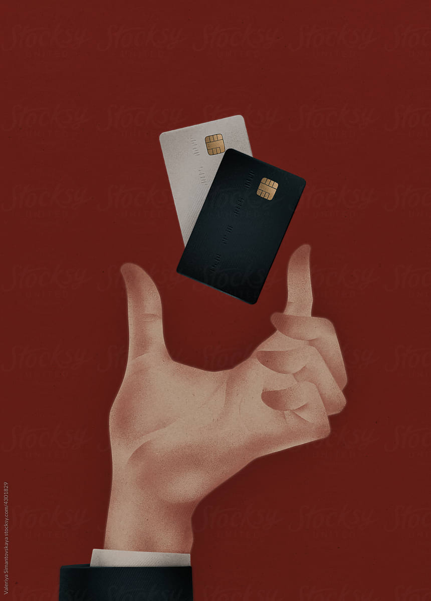 hand holds two bank credit cards on a red background
