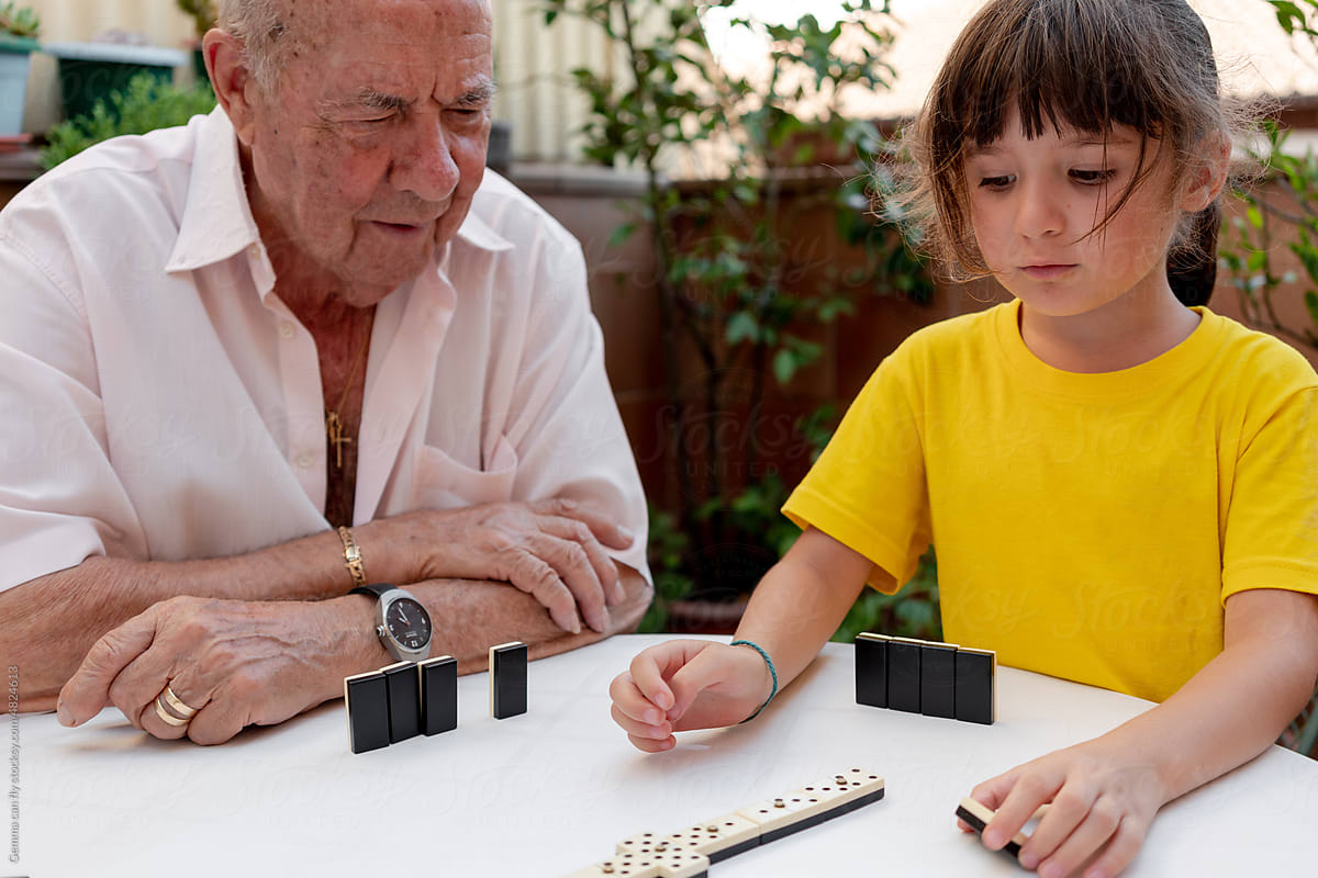 Family time playing domino with great grandfather in a residence