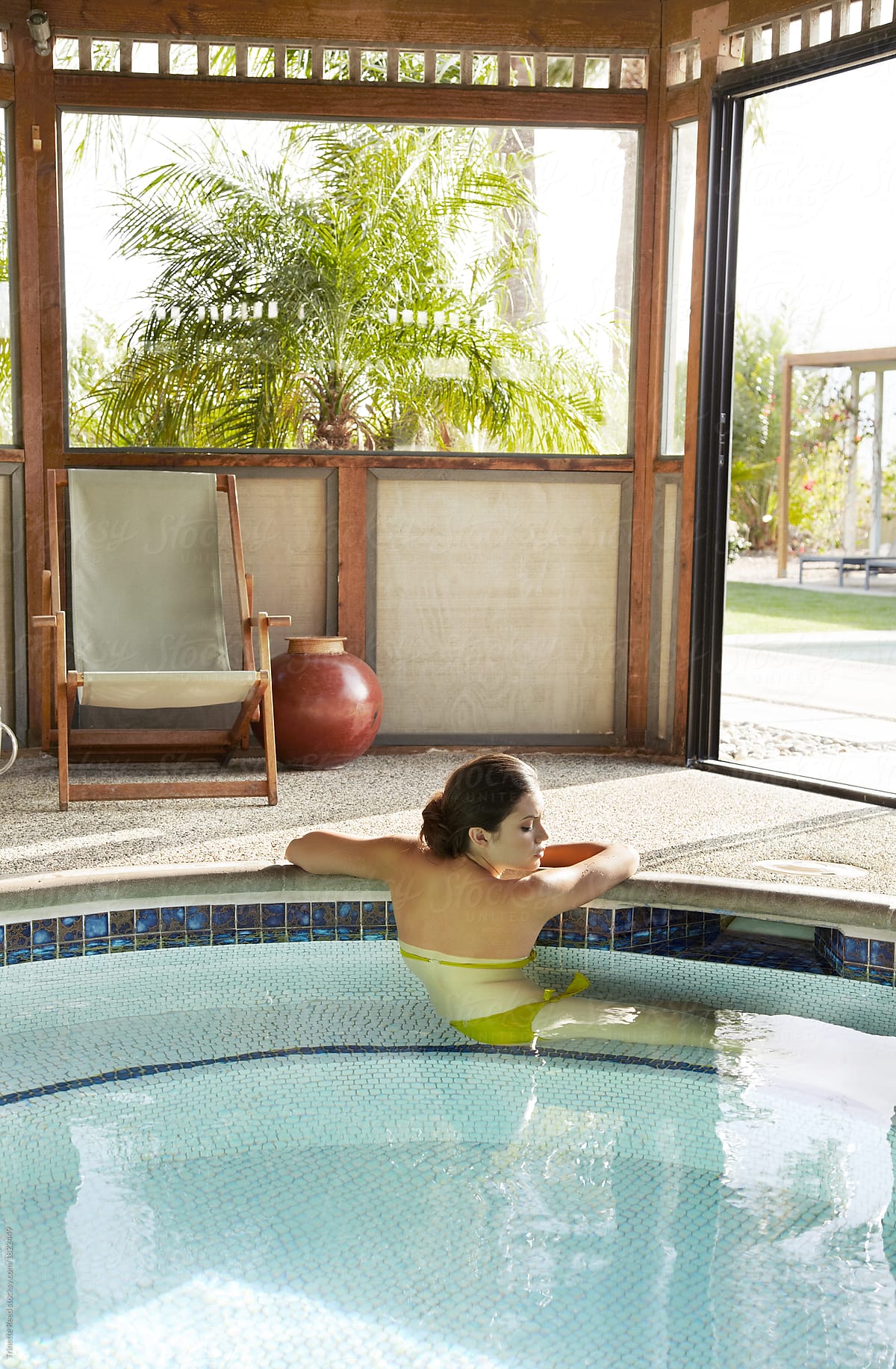 Beautiful Hispanic woman relaxing in pool at hot springs