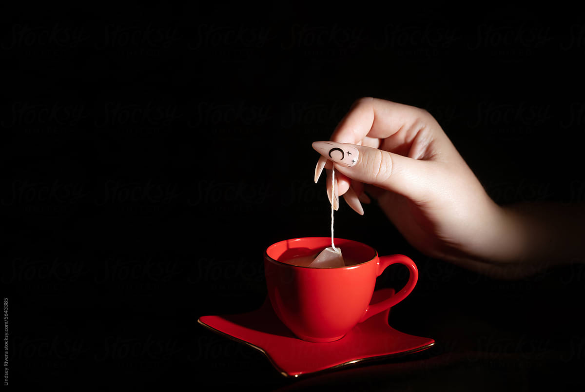 Woman\'s Hand Making Tea