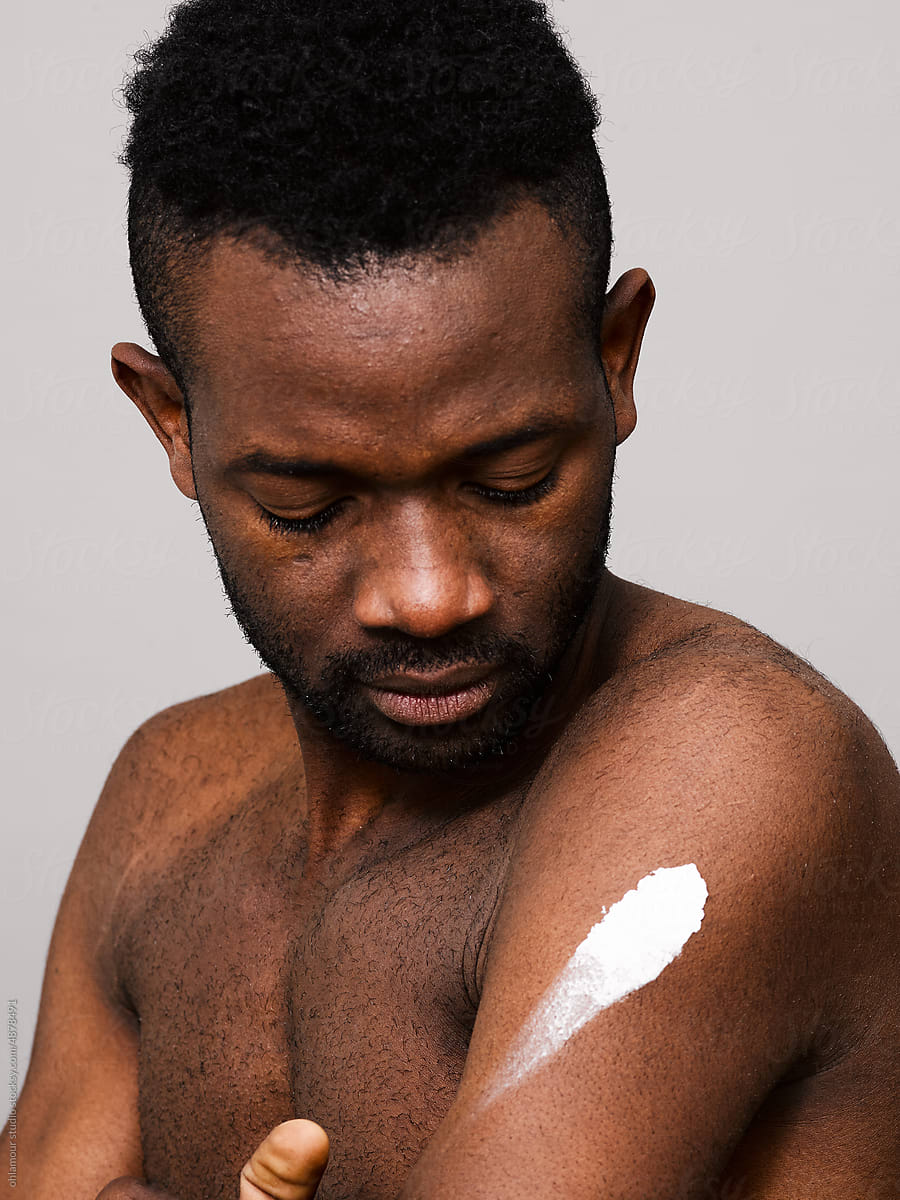 Man with smudge of lotion on his arm