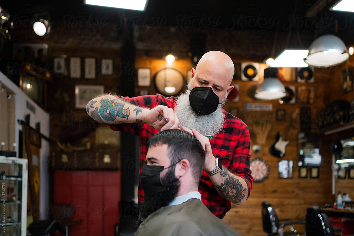 Barber And Client Using A Face Mask.