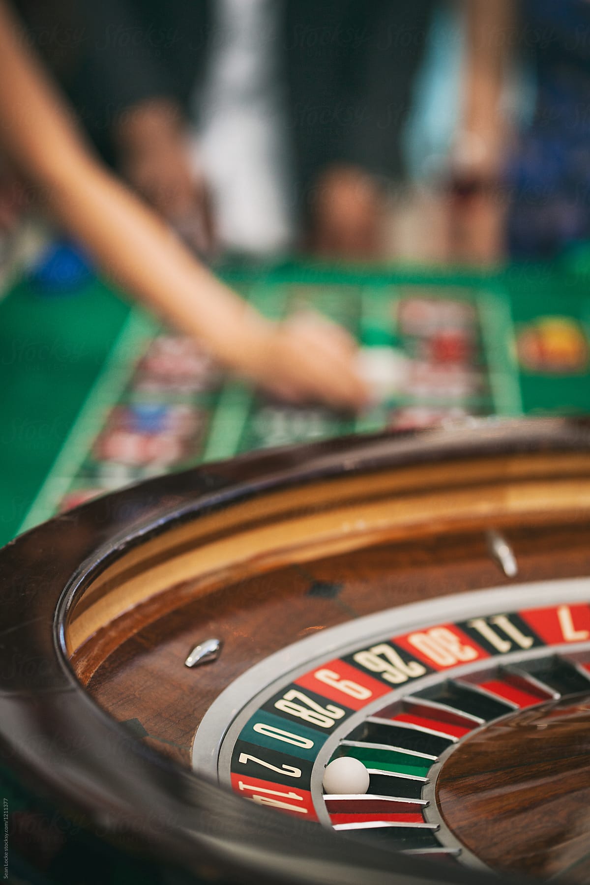 Casino: Focus On Ball In Numbered Slot On Roulette Wheel