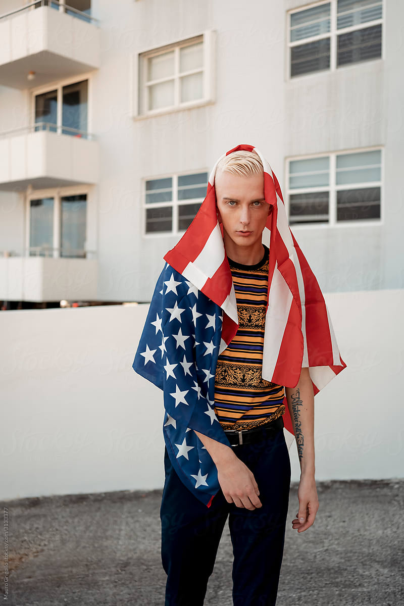 Stylish blond man with an american flag on head