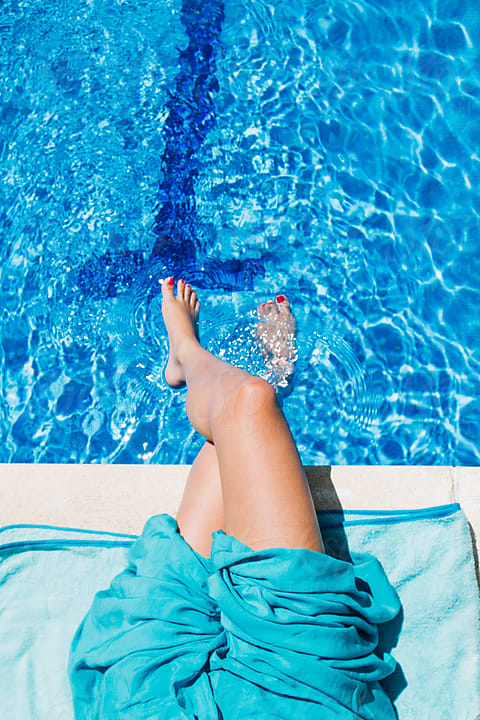 Young Woman´s Legs Into A Swimming Pool During A Summer Day by Stocksy  Contributor Inuk Studio - Stocksy