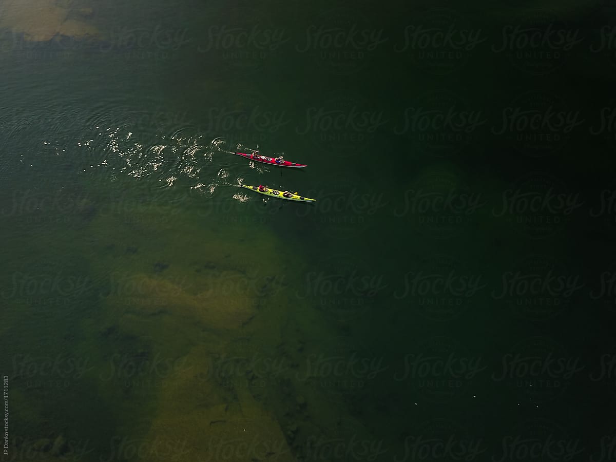 Aerial Photo of Two Double Sea Kayaks Travelling in Water on Camping Trip in Remote Wilderness