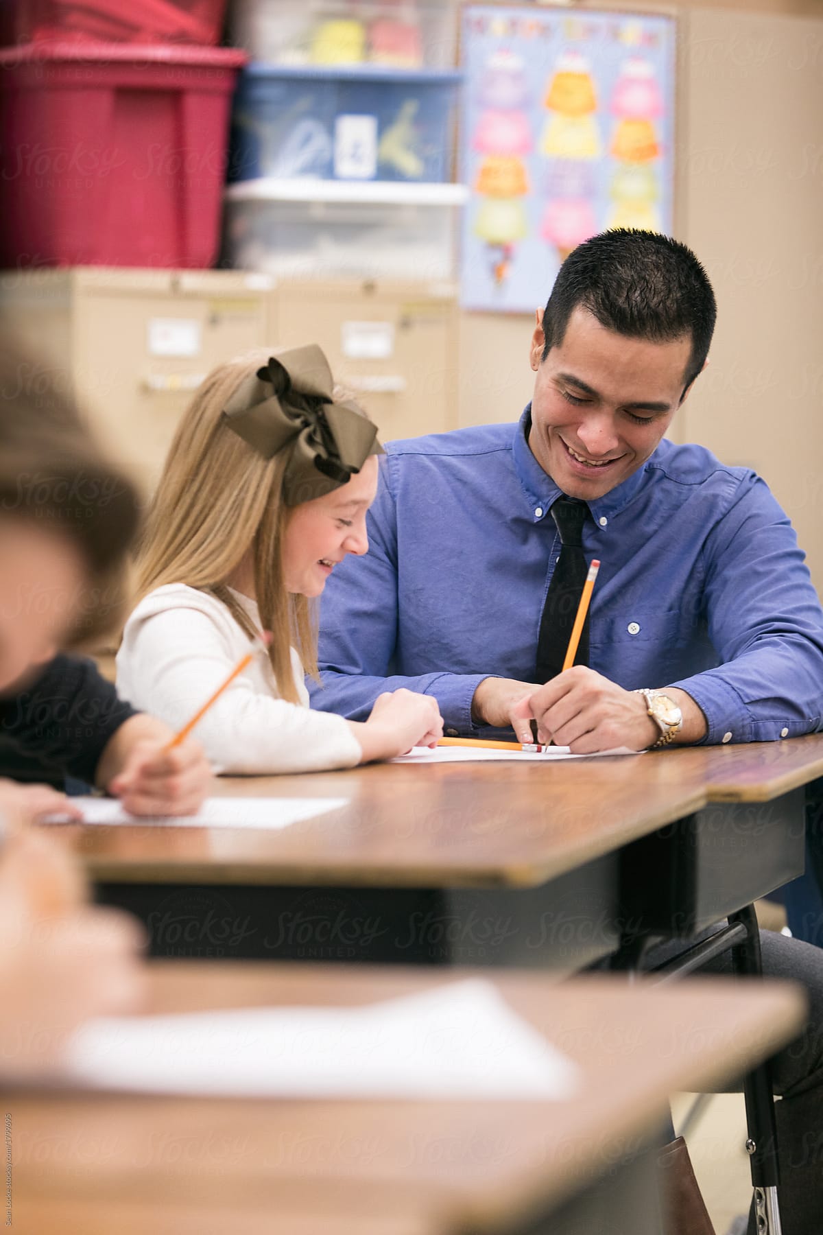 Classroom: Hispanic Teacher Helps Girl With Homework