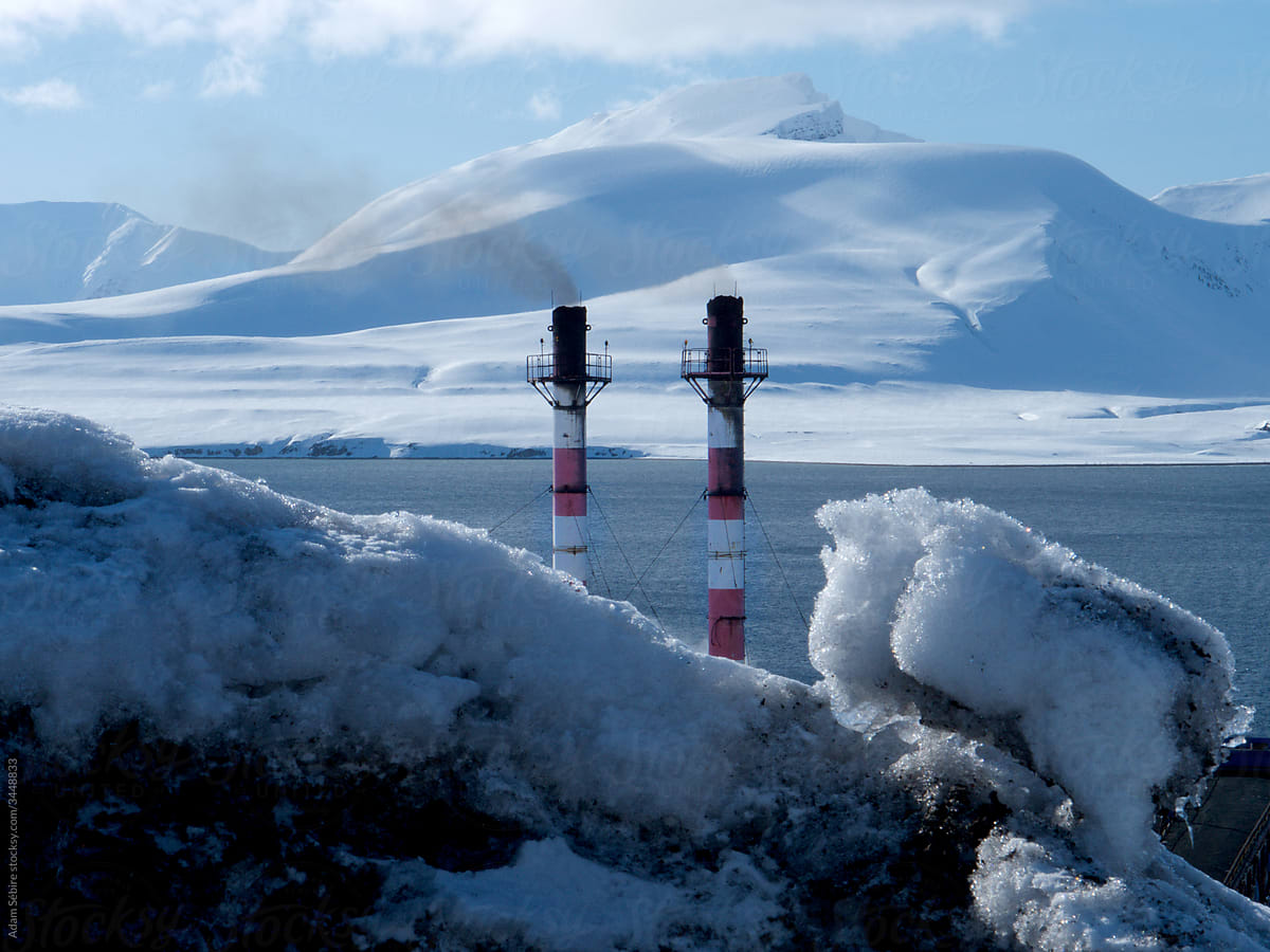 Coal mine chimney smoke stacks in melting mountain snows, Barentsburg, Svalbard