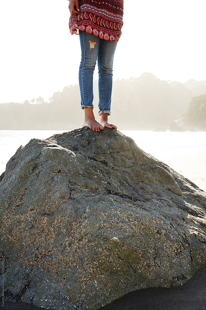 Waist Down Portrait Of Mixed Race Woman Standing On A Rock Del Colaborador De Stocksy