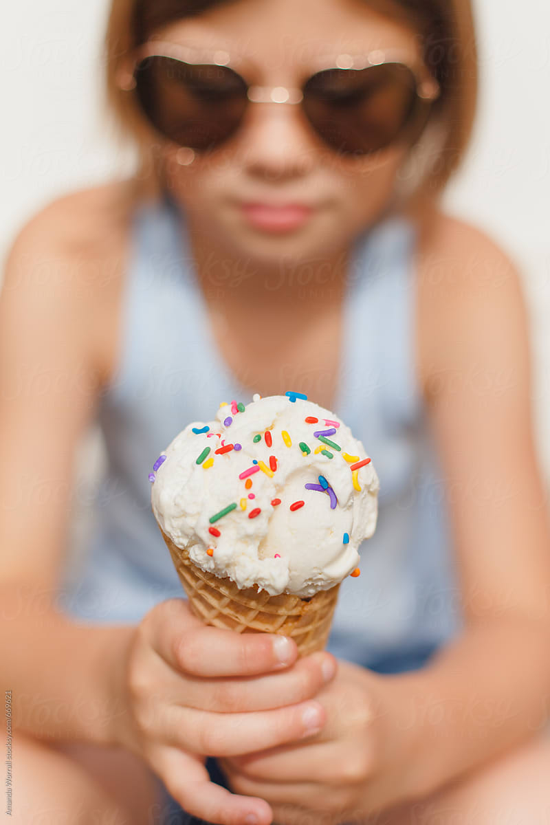 Girl Looking At Her Ice Cream Cone With Sprinkles By Stocksy